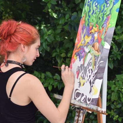 Raven paints on-site at the Arts Market. Submitted photo