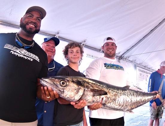 David Mapson, Neal Hammons, Tristan Mapson and Justin Hammons, from left, are pictured with their first-place kingfish, weighing an impressive 47.7 pounds. Team Taking the Bait took home the top prize of $10,000. Photo by Terry Lacoss