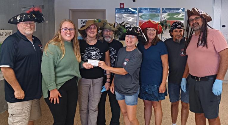 Pictured are, from left, Greg Carter (Pirate public relations chair, Teller of Tales, aka Big G), Barnabas representative Noel Lehman (Pirate, aka Kalypso), Charles Lehman (Pirate, aka Captain Kaz), Juleeann Stewart (Pirate Treasurer, Keeper of Coins, aka Jewels of the Island), Gwen Cox (Pirate, aka Ember), Brian Leary (Pirate, aka Swordmaster) and Robert Chestnut (Pirate, aka Bob).