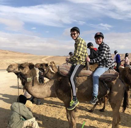 Sean Rosenthal (left) and friend Jake Schwartz (right) on a camel in the desert of Israel.  Photo by Sean Rosenthal/News-Leader
