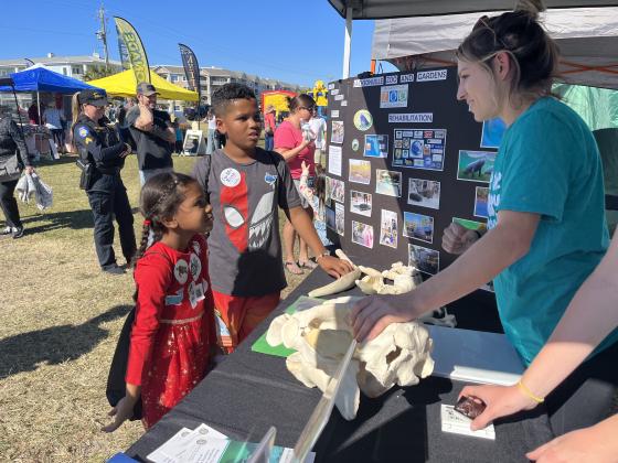 From left, Amaya and Armando Arroyo learn about the animal rehabilitation program at the Jacksonville Zoo. Photo by Sean Rosenthal/News-Leader