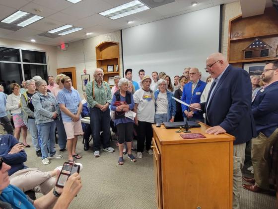 Surrounded by supportive citizens, Fernandina Beach City Commissioner Chip Ross read a proclamation recognizing Transgender Day of Remembrance, after Mayor Bradley Bean declined to do so. Photo by Julia Roberts