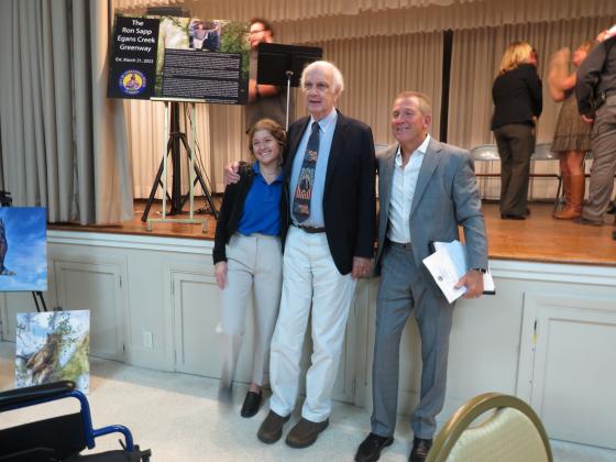Ron Sapp, center, with his granddaughter to his left and event master of ceremonies, Robert Peters, on his right at the recent dedication ceremony. Photo by Tracy Dishman/News-Leader