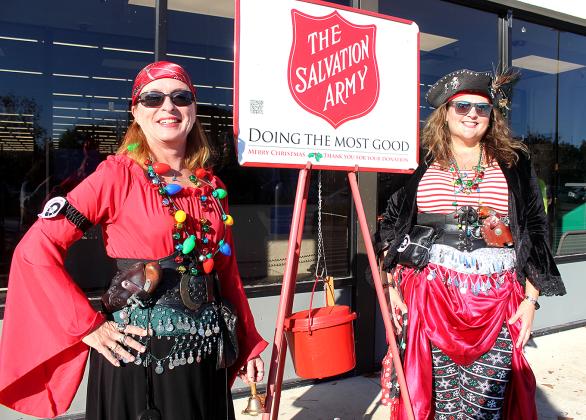 Fernandina Pirates Club members Julie Stewart (aka Jules of the Island), left, and Jill Johnson (aka Sea-Kay McGee) ring bells outside the Fernandina Beach Walmart on Wednesday. Photo by Beth Jones/News-Leader
