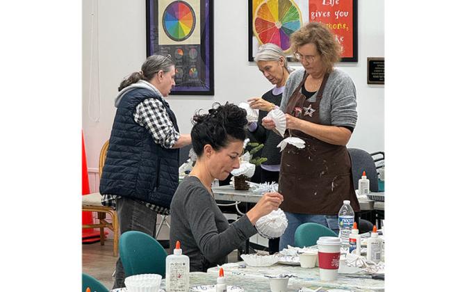 Students at the Island Art Association’s Sunday on Second program create Christmas ornaments.