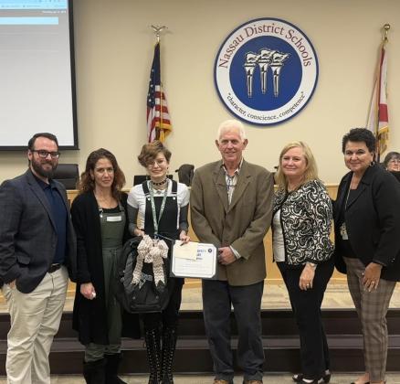 Sharing a photo at a recent school board meeting that highlighted students accomplishments are, from left, Johnathan Goodwin, assistant principal at Callahan Middle School, Izzy Spivey’s mother, Izzy Spivey, a family friend of the Spiveys, Kim Shumate, principal of Callahan Middle School, and Kathy Burns, superintendent of Nassau County School District. Submitted