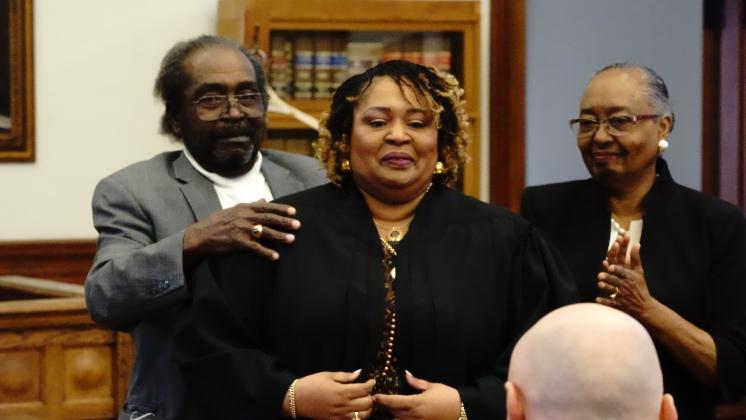 Parents Veronica and DiWell Wallace had the honor of robing their daughter, Deirdre Wallace, as the first full-time magistrate to serve the Nassau County Courts at a ceremony on Wednesday. Images Courtesy 4th Judicial Circuit