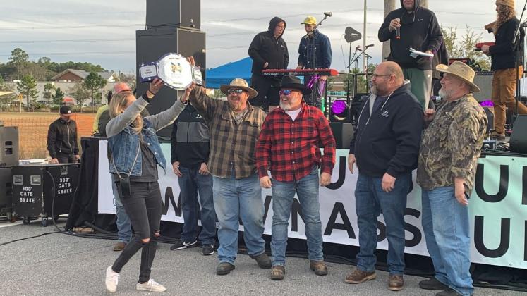 The Loggerheads team, from left, Commissioner Klynt Farmer, Wes “Cowboy” Watson, Brian Jahay and Joey Rehberg are presented with a trophy for winning the bicentennial chili cook-off event. Photo by Sabrina Robertson