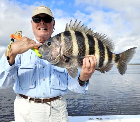 Capt. Allen Mills guided Tom Kien, above left, to this huge 9-pound sheepshead this past week right on the full moon. Photo by Terry Lacoss
