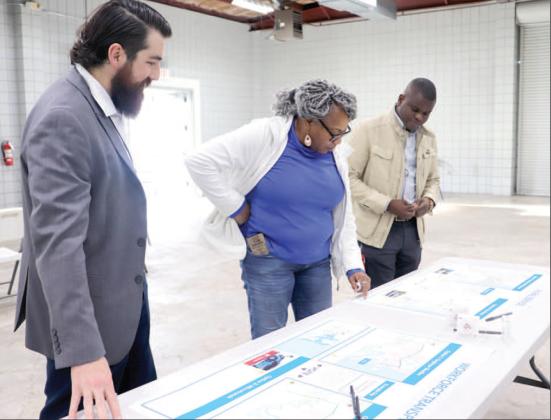 Callahan resident Eleby Harris looks over proposed Jacksonville Transportation Authority plans that could provide bus service to western Nassau residents. She is joined by JTA Director of Planning and Sustainability Xan Traversa and another JTA representative. Photo by Kathie Sciullo/Community Newspapers