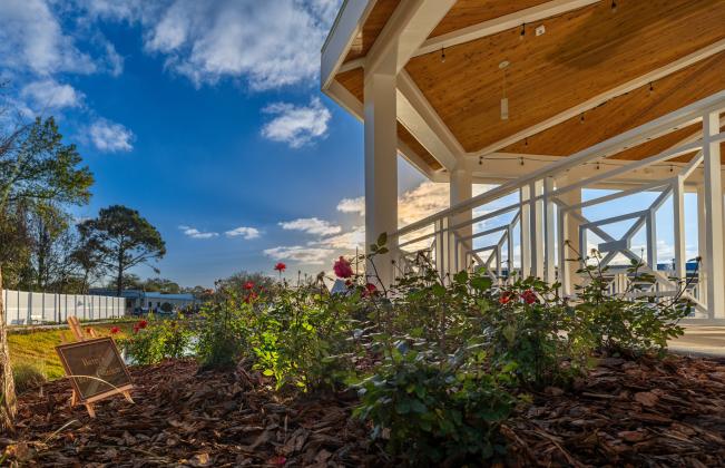 “Betty’s Rose Garden” brightens a large, flowering bed, providing a classy touch to any festivity. More than 20 varieties of mature trees, flowering plants, bushes and grasses dot the landscape. Photo by Rikky Sanders, Rikky Sanders Photography