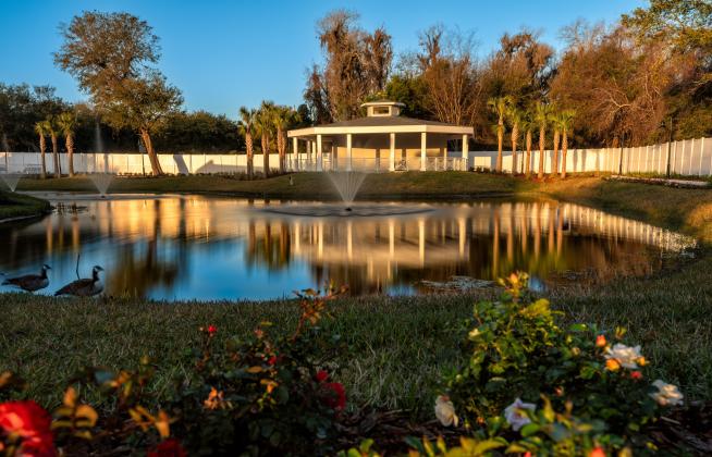 At 1,200 square feet, the ADA-accessible pavilion features modern architecture with a nostalgic flair. An inlaid wood ceiling houses lighting, speakers and Wi-Fi; an audio system is incorporated in the structure. Overlooking the water feature, complete with three fountains, the pavilion can seat 120 guests theatre-style and 60 guests at round banquet tables. Photo by Rikky Sanders, Rikky Sanders Photography
