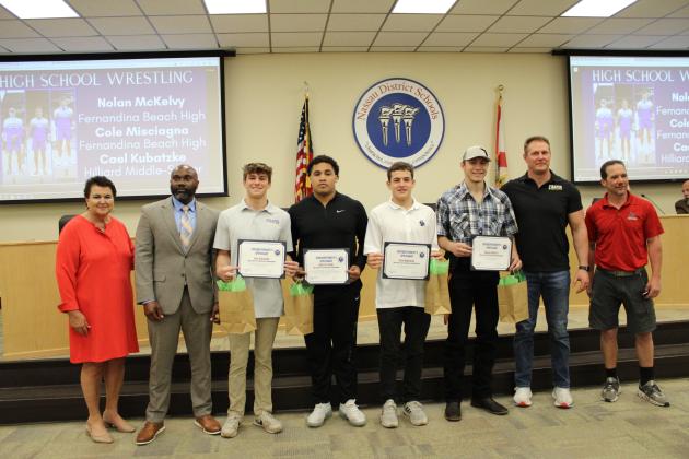 Student athletes were recognized for their accomplishments at the Florida high school boys state wrestling championships. From left, Kathy Burns, George Raysor, Cael Kubatzke, Braylen Ricks, Cole Misciagna, Nolan McKelvy, Eric Kubatzke and Jeremy Ferry. Photo by Tracy McCormick-Dishman/News-Leader