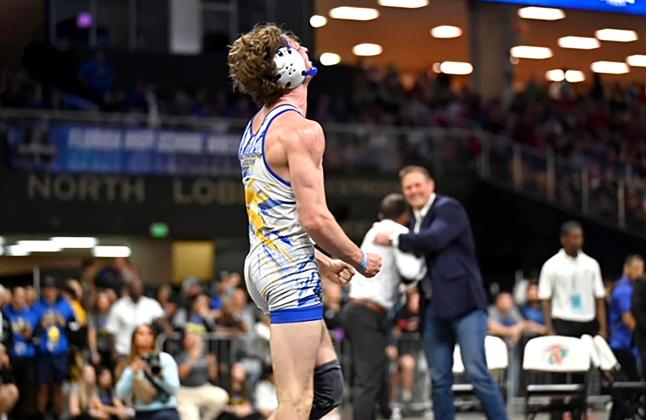 Enzo Gamba, a senior at Fernandina Beach High School, won the state championship in the 157-pound weight class Saturday during the 1A wrestling championships at the Silver Spurs Arena in Kissimmee. Gamba’s coaches celebrate in the background. FBHS PHOTOS BY ERIN MAHONEY AND STORMY KUBATZKE/SPECIAL