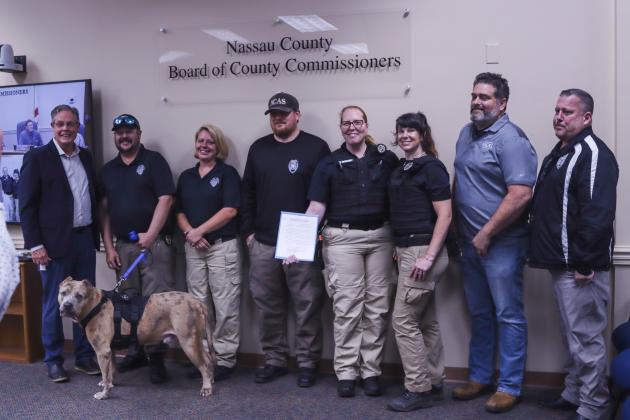 The Nassau County Board of County Commissioners proclaimed next week, April 14-20, as Animal Care and Control Appreciation Week in the county. Nassau County Animal Control staff brought a special guest with them to the meeting Monday.  Photo by Ashley Chandler/News-Leader