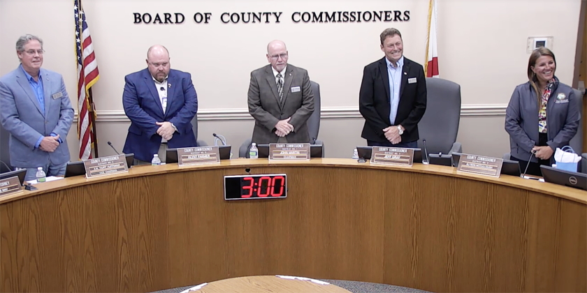 The county commissioners stand before the invocation and pledge at the Nassau County Board of County Commissioners meeting Monday. From left, Commissioner A.M. “Hupp” Huppman, Klynt Farmer, John Martin, Jeff Gray and Alyson McCullough. Submitted