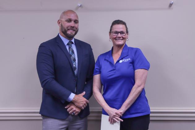 County Manager Taco Pope poses with Laura Marino, who was honored at the Nassau County Board of County Commissioners meeting Wednesday morning for her 20 years of work with University of Florida Institute of Food and Agricultural Sciences Extension. Photo by Ashley Chandler/News-Leader
