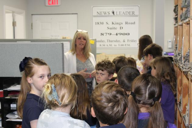 News-Leader Editor Tracy Dishman explains the large archive of past News-Leader editions and how they are organized in the newsroom.  Photo by Brooke Bird/News-Leader