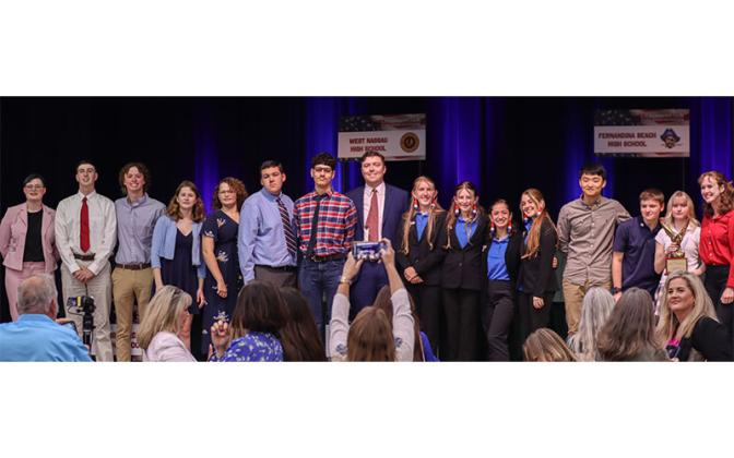 Four high school teams and a home-schooled team gather on the Wildlight Elementary School stage after the Constitution Bowl. Photo by Ashley Chandler/News-Leader