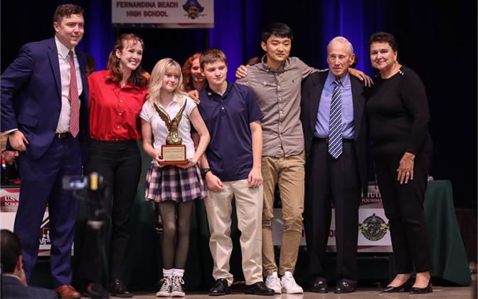 The Yulee High School winning team, from left, Mayor of Fernandina Beach, Bradley Bean, Lyla Johnson, Reagan Jeffers, Jacob Clayton, Richard Guo, Dean of the University of US Howard Pines and Superintendent of Schools, Kathy Burns. Photo by Ashley Chandler/News-Leader