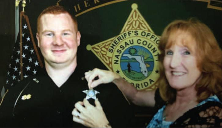 Brenda Moyers pins Josh Moyers’ badge on as he begins his career as a deputy with the Nassau County Sheriff’s Office. Moyers’ family shared the photo as victim impact statements were read in court last week. Submitted photo
