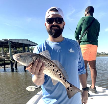 Chef Omar Collazo is pictured with his favorite fish to both catch and prepare, utilizing his award-winning Blackened Redfish recipe.
