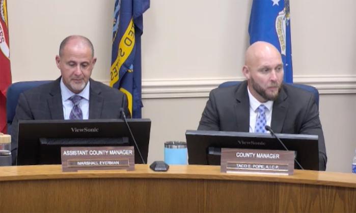 County Manager Taco Pope, right, discusses the Tourist Development Tax on Monday at the Board of County Commissioners meeting as Assistant County Manager Marshall Eyerman, left, listens.  Submitted