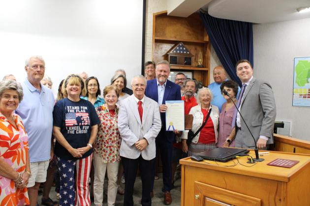 First Baptist Church of Fernandina Beach pastor Zack Terry holds a proclamation presented to him and John Meisburg establishing June 29 as Christian Heritage Day. There is a Christian Heritage parade scheduled for that day. Participants are being asked to submit a form requiring they agree with certain religious beliefs, which some people being is causing division in the community. Photo by Julia Roberts/News-Leader