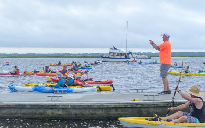 Cross the Line founder Bill Cimino takes a photo of paddlers Saturday at the Cross the Line Paddle for Veterans event. Photos by Mariah Lovin/The Barefoot Photographer