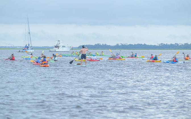 Paddlers take to the water Saturday at the Cross the Line Paddle for Veterans event. Photos by Mariah Lovin/The Barefoot Photographer