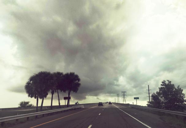 Storm clouds hover over Thomas J. Shave Jr. Bridge on Wednesday morning, one day after the bridge was briefly closed when officers observed what appeared to be two funnel clouds forming nearby. Ashley Chandler/News-Leader