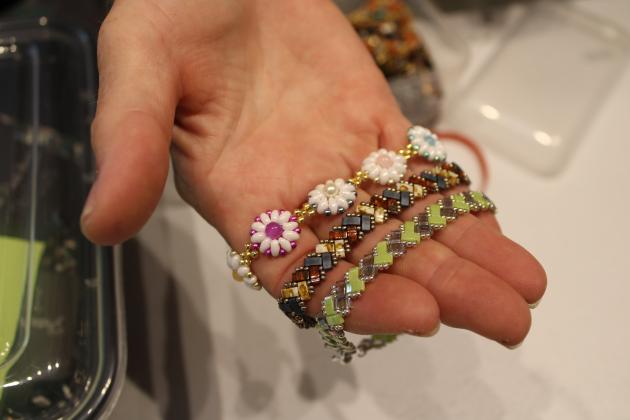 A volunteer shows samples of the myriad of designs crafted at Saturday’s event. Photo by Pamela Bushnell/News-Leader