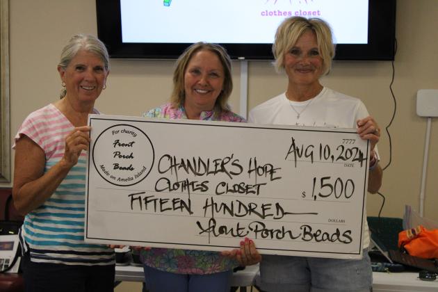 At Saturday’s event, Front Porch Beads presented a donation of $1,500 from sales of their jewelry to Chandler’s Hope Clothes Closet, a local charity serving the homeless. Shown from left are Joan Shelley and Janet Chatfield with Front Porch Beads and Michele Holbrook, founder of Chandler’s Hope.  Photo by Pamela Bushnell/News-Leader