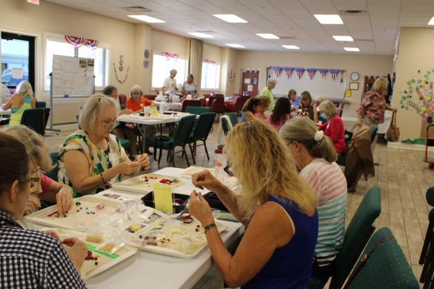 On a recent Saturday, 25 volunteers met at the Nassau County Council on Aging to craft bracelets to sell in support of local charities. The group meets at different locations twice a month. Photo by Pamela Bushnell/News-Leader