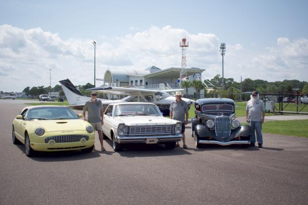 Cutline: From left, Amelia Cruizers Gene Freund’s 2002 Thunderbird, Angelo Miragliotta’s 1965 Ford Galaxy and Earl Wagner’s 1933 Ford 5-window coupe pose in front of FOFA’s Karen Atkins’ 1978 Cessna 182Q. Photo by Brian Douglas/Special for the News-Leader