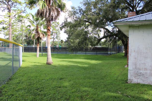 The proposed location of the new lift station is in what Utilities Director Andre Desilet called a “dead space,” a triangular space between the ball field, tennis courts and Boy and Girl Scout facilities and a garden area called Volunteer Grove. Photo by Julia Roberts/News-Leader