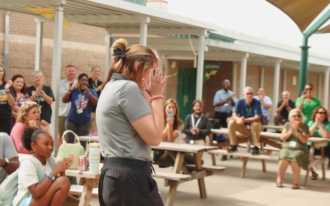 Ashley Murray is surprised with a check from TaxSlayer Gator Bowl on Wednesday at Yulee High School where Murray teaches. The check is a part of the Most Valuable Teacher Initiative. The $1,000 is to use in her classroom. Photo by Ashley Chandler/News-Leader