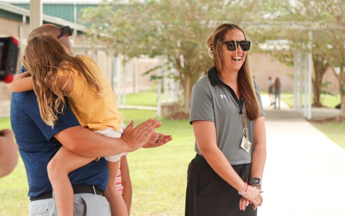 Ashley Murray, right, is surprised with a check from TaxSlayer Gator Bowl, as a part of the Most Valuable Teacher Initiative on Wednesday at Yulee High School where Murray teaches. The check, for $1,000, is to use in her classroom. Photo by Ashley Chandler/News-Leader