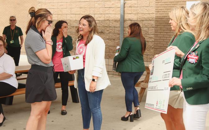 Ashley Murray, left, is surprised with a check from TaxSlayer Gator Bowl, as a part of the Most Valuable Teacher Initiative. The check, for $1,000, is to use in her classroom. Also pictured, Kayla Vanderlaan, middle, Director of Marketing and Community Relations for Gator Bowl. Photo by Ashley Chandler/News-Leader