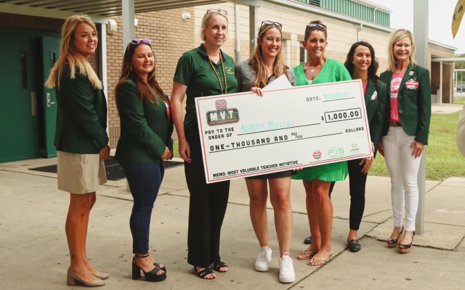 From Left: Jennifer Estes, Dawn Wilson, Principal Lori Amos, Ashley Murray, Rachel Norfleet, Emily Andrews and Christie Hill pose with a check from TaxSlayer Gator Bowl that Ashley received as a part of the Gator Bowl's Most Valuable Teacher Initiative. Photo by Ashley Chandler/News-Leader