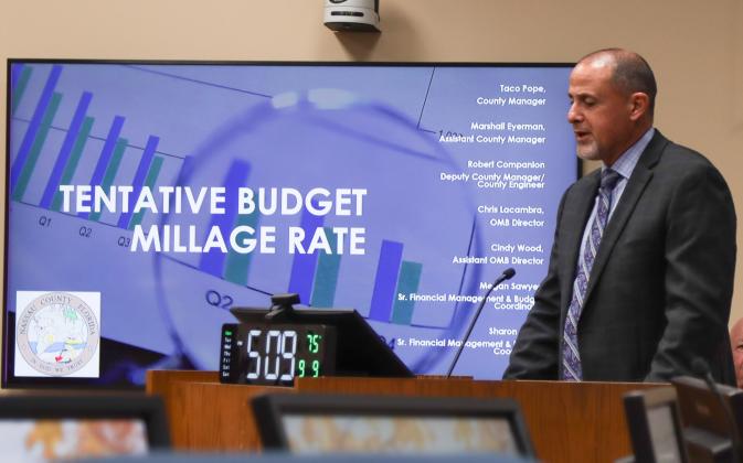 Assistant County Manager Marshall Eyerman presents the now-adopted budget and millage rates Monday at the Board of County Commissioners Meeting. Ashley Chandler/News-Leader