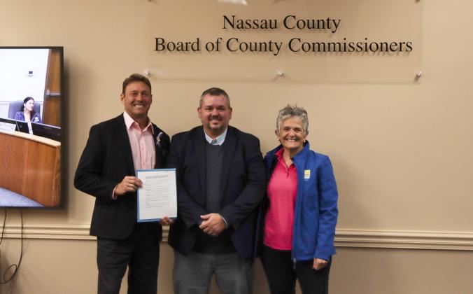 From left, Commissioner Jeff Gray presents the proclamation dedicating the week of Oct. 25 through Nov. 2 as Mobility Week to Deputy County Manager and County Engineer Robert Companion and Barb Baptista, member of the Transportation Disadvantaged Board on Oct. 16 at the Board of County Commissioners meeting. Photo by Ashley Chandler/News-Leader