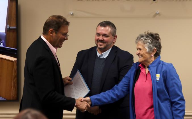 From left, Commissioner Jeff Gray presents the proclamation dedicating the week of Oct. 25 through Nov. 2 as Mobility Week to Deputy County Manager and County Engineer Robert Companion and Barb Baptista, member of the Transportation Disadvantaged Board on Oct. 16 at the Board of County Commissioners meeting. Photo by Ashley Chandler/News-Leader