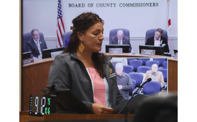 Nassau County Commissioner Alyson McCullough reads the proclamation declaring the week of Oct 20 - 26 as Breast Cancer Awareness Week in the county, and today as Pink Day on Oct. 16 at the Board of County Commissioners meeting. Photo by Ashley Chandler/News-Leader