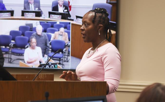 Breast Cancer Survivors Shanita Burks speaks Oct. 16 at the Board of County Commissioners meeting after receiving a proclamation from the board declaring the week of Oct 20 - 26 as Breast Cancer Awareness Week in the county, and today as Pink Day. Burks said she was a mother of two and active duty in the Navy when she was diagnosed. Photo by Ashley Chandler/News-Leader