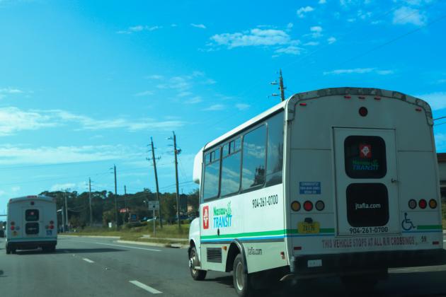 Two Jacksonville Transportation Authority (JTA) buses can be seen driving in Nassau County. Photo by Ashley Chandler/News-Leader