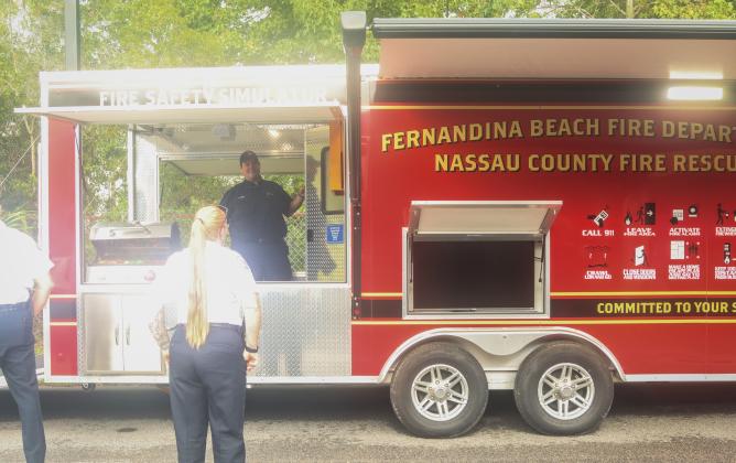 Thomas Ford, fire inspector for Nassau County Fire Rescue, stands on the back deck of the new city/county Safety Education Trailer. Photo by Ashley Chandler/News-Leader