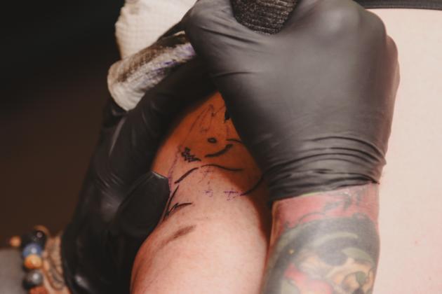 Kayla Altman tattoos one of two flash-tattoo fox designs on Elizabeth Johnson on Sunday at The Salty Fox Tattoo &amp; Apothecary. Johnson got two fox tattoos and traveled from Jacksonville to attend the event. Photo by Ashley Chandler/News-Leader