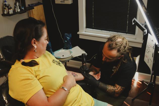 Sailor Dave tattoos a flash-tattoo fox design on Sunday at The Salty Fox Tattoo &amp; Apothecary. Photo by Ashley Chandler/News-Leader