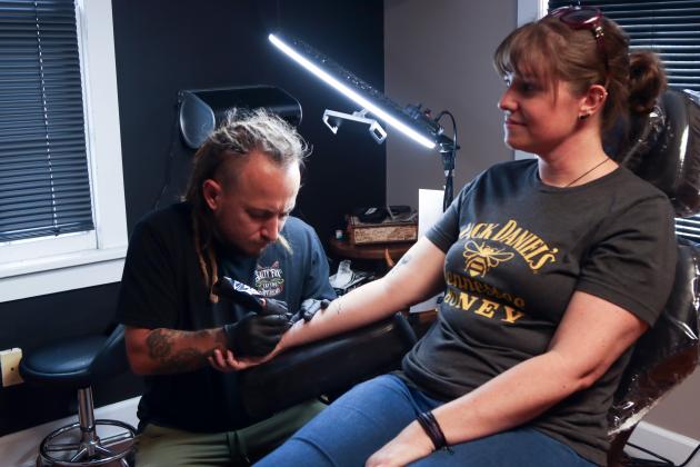 Sailor Dave tattoos a flash-tattoo fox design on Sunday at The Salty Fox Tattoo &amp; Apothecary. Photo by Ashley Chandler/News-Leader